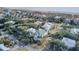 An aerial view of picturesque homes surrounded by lush greenery, with the beach visible in the distance at 4000 Cameron Blvd, Isle of Palms, SC 29451