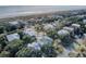 An aerial shot showcasing beautiful homes surrounded by mature trees, with a glimpse of the nearby beach at 4000 Cameron Blvd, Isle of Palms, SC 29451
