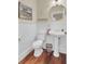 Charming powder room with beadboard wainscoting and pedestal sink at 4000 Cameron Blvd, Isle of Palms, SC 29451