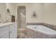 Bright bathroom features a soaking tub with decorative tile surround, and a glass enclosed shower at 4000 Cameron Blvd, Isle of Palms, SC 29451