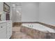 Bathroom features a jacuzzi-style tub with a tiled base and shower stall at 4000 Cameron Blvd, Isle of Palms, SC 29451