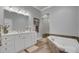Primary bathroom with double vanity, walk-in shower, and jacuzzi bathtub at 4000 Cameron Blvd, Isle of Palms, SC 29451