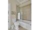 Bathroom with a white toilet and tub/shower combo with glass doors and decorative tile surround at 4000 Cameron Blvd, Isle of Palms, SC 29451