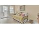 Comfortable bedroom featuring outdoor access, plantation shutters, and a decorative daybed at 4000 Cameron Blvd, Isle of Palms, SC 29451