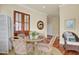 Cozy dining area with seating for four, a wood framed glass door and a view into another room at 4000 Cameron Blvd, Isle of Palms, SC 29451
