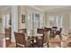 Bright dining area with a glass table and wicker chairs near the large shuttered windows at 4000 Cameron Blvd, Isle of Palms, SC 29451