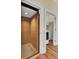 Home elevator and laundry room featuring hardwood floors, an elevator and modern washer and dryer at 4000 Cameron Blvd, Isle of Palms, SC 29451
