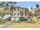 Charming two-story home with landscaped yard, a two car garage and inviting front porch at 4000 Cameron Blvd, Isle of Palms, SC 29451