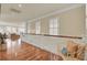 Upstairs hallway with lots of natural light, featuring a cozy reading bench at 4000 Cameron Blvd, Isle of Palms, SC 29451