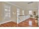 Second story hallway featuring hardwood flooring, multiple windows and natural lighting at 4000 Cameron Blvd, Isle of Palms, SC 29451