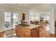 Open kitchen with island cooktop adjacent to an outdoor dining area at 4000 Cameron Blvd, Isle of Palms, SC 29451
