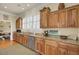 Bright kitchen features custom wood cabinets, granite countertops, and modern stainless steel appliances at 4000 Cameron Blvd, Isle of Palms, SC 29451