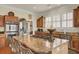Well-lit kitchen shows an island, stainless steel appliances, and custom wood cabinets at 4000 Cameron Blvd, Isle of Palms, SC 29451