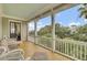 Inviting porch has comfortable wicker seating, white railings, and views of the lush landscaping at 4000 Cameron Blvd, Isle of Palms, SC 29451