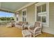 Inviting porch has comfortable wicker seating and views at 4000 Cameron Blvd, Isle of Palms, SC 29451