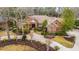 Aerial view of a brick home with lush landscaped yard, curved walkway, and mature trees at 4140 Club Course Dr, North Charleston, SC 29420