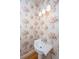 Quaint half-bath with floral wallpaper, pedestal sink, and traditional fixtures at 4140 Club Course Dr, North Charleston, SC 29420