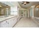 Bright bathroom with dual vanities, granite countertop, large mirror, tub and tiled floor at 4140 Club Course Dr, North Charleston, SC 29420