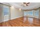 Bright bedroom featuring tray ceilings, ample natural light, and hardwood floors at 4140 Club Course Dr, North Charleston, SC 29420