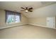 Well-lit bedroom features a ceiling fan, large windows and neutral carpet at 4140 Club Course Dr, North Charleston, SC 29420