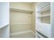 A closet with white shelving and rods on beige carpet at 4140 Club Course Dr, North Charleston, SC 29420