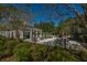 Community gathering area with seating, tables, umbrellas and bar area surrounded by lush foliage and mature trees at 4140 Club Course Dr, North Charleston, SC 29420