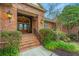 Charming brick home featuring a covered front entrance with glass paneled double doors and professional landscaping at 4140 Club Course Dr, North Charleston, SC 29420