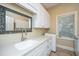 Bright laundry room with white cabinets, granite countertops, and stainless steel sink at 4140 Club Course Dr, North Charleston, SC 29420