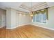 Spacious living room with gleaming hardwood floors, tray ceilings, decorative window treatments, and recessed lighting at 4140 Club Course Dr, North Charleston, SC 29420