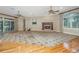 Expansive living room with fireplace, ceiling fans, and access to outdoor patio at 4140 Club Course Dr, North Charleston, SC 29420