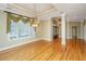 Spacious living room featuring hardwood floors, large windows, and elegant chandelier at 4140 Club Course Dr, North Charleston, SC 29420