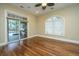 Bright living room with hardwood floors, ceiling fan, and a sliding glass door leading to outdoor patio at 4140 Club Course Dr, North Charleston, SC 29420