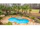 Beautiful kidney-shaped pool, stone surround, raised spa and lush landscaping at 4140 Club Course Dr, North Charleston, SC 29420