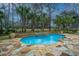 Beautiful pool with a spa and stone accents offers a tranquil backyard retreat at 4140 Club Course Dr, North Charleston, SC 29420