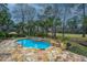 Stunning pool featuring a stone patio and lush landscaping in a private backyard setting at 4140 Club Course Dr, North Charleston, SC 29420