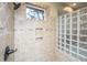 Close-up of a shower featuring tiled walls with a built-in niche and glass block accent at 4140 Club Course Dr, North Charleston, SC 29420