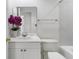 Bright bathroom features white fixtures, tiled walls and a faux orchid for decor at 4850 Habersham Ln, Summerville, SC 29485