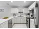 A bright kitchen with white cabinets and stainless steel appliances at 4850 Habersham Ln, Summerville, SC 29485