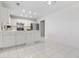 Kitchen with stainless appliances, white cabinets, tile floors and chandelier at 4850 Habersham Ln, Summerville, SC 29485
