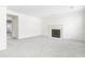 An airy living room boasts a decorative fireplace, freshly painted walls, and new neutral carpeting at 4850 Habersham Ln, Summerville, SC 29485