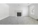 Clean living room featuring a decorative fireplace, new carpet, fresh paint, and a single window at 4850 Habersham Ln, Summerville, SC 29485