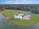 Aerial of community amenities featuring a pool, clubhouse, lake and playground at 502 Pontoon Rd, Huger, SC 29450