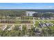 Aerial view of a neighborhood with a lake, showcasing well-manicured lawns and lush trees at 502 Pontoon Rd, Huger, SC 29450