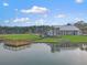 Aerial view of waterfront community amenities: pier, lake, pool and clubhouse at 502 Pontoon Rd, Huger, SC 29450