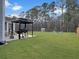 Expansive backyard with a built-in grill area, a fire pit, and plenty of space for outdoor activities at 502 Pontoon Rd, Huger, SC 29450