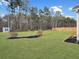 Expansive backyard featuring a large grassy area with a storage shed and landscaping at 502 Pontoon Rd, Huger, SC 29450