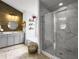 Elegant bathroom with marble tile, a glass-enclosed shower, and a soaking tub in the background at 502 Pontoon Rd, Huger, SC 29450