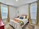 Bright bedroom with neutral walls, colorful accents, and natural light from windows with decorative curtains at 502 Pontoon Rd, Huger, SC 29450