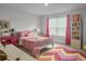 Bright bedroom with a large window and a charming decorative accents that makes the room feel cozy at 502 Pontoon Rd, Huger, SC 29450