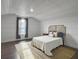 Well-lit bedroom with a shiplap wall, decorative headboard, and natural light from a large window at 502 Pontoon Rd, Huger, SC 29450